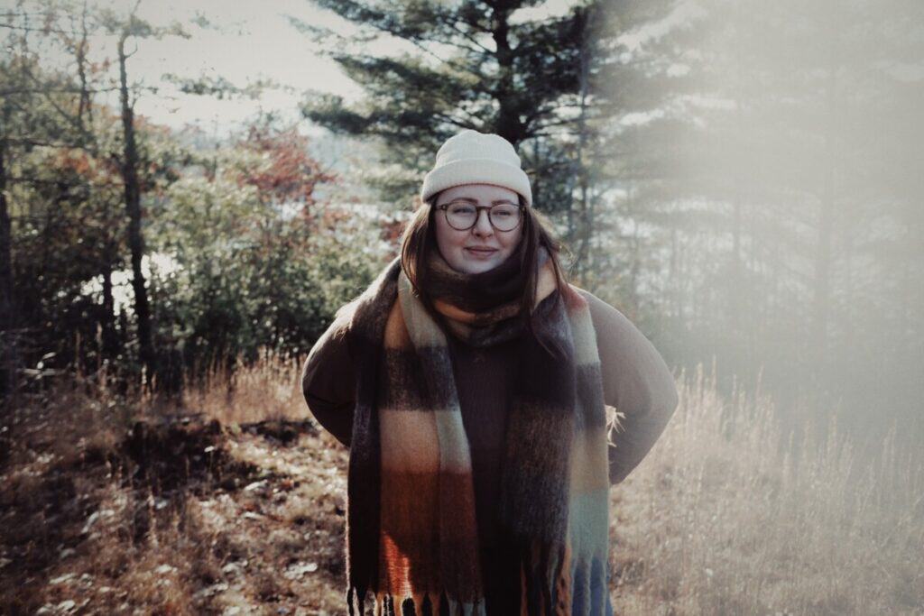 Woman with a white hat and plaid scarf