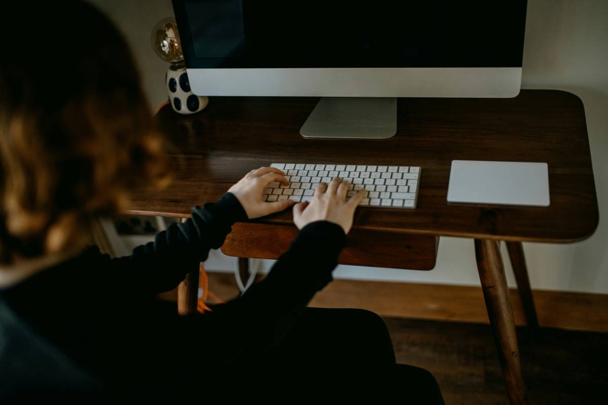 Person typing on a keyboard with both hands